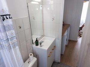 a white bathroom with a sink and a toilet at Le Sympathique - Petit Déjeuner, Netflix, Jacuzzi in Rouen