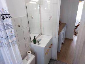 a white bathroom with a sink and a toilet at Le Sympathique in Rouen