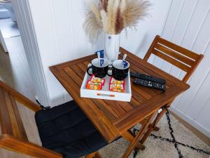 a table with a tray of food and a remote control at Le Sympathique in Rouen