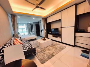 a living room with a couch and a tv at Mont kiara 5-Star Deluxe Suite 2-4pax in Kuala Lumpur