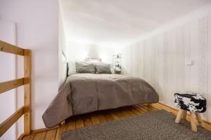 a bedroom with a bed in a white wall at Balint Budapest Apartment next to Synagogue, best location in city center in Budapest