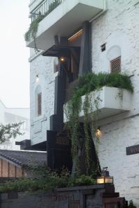 a building with a staircase with plants on it at Banla Boutique Hotel in Da Lat +117 photos