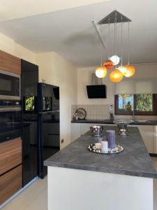 a kitchen with a black counter top in a kitchen at Ionion Beachfront Villa in Ayia Napa