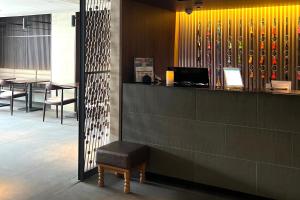 a restaurant with a bench and a bar with chairs at Kyoto Itoya Hotel in Kyoto +22 photos