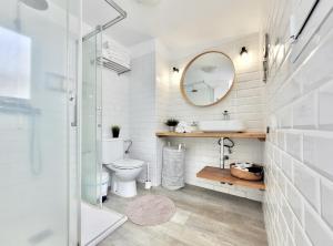 bagno con servizi igienici, lavandino e specchio di Summer Breeze Penthouse a Puerto de la Cruz