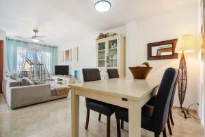 a living room with a wooden table and chairs at Atico Duplex Pepe y Rosi in Cunit