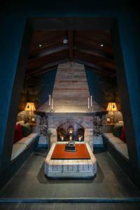 a living room with a stone fireplace in a house at Banla Boutique Hotel in Da Lat +127 photos