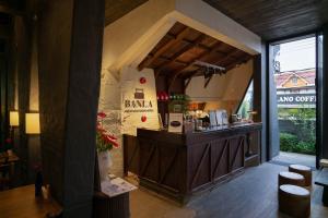 a restaurant with a bar with stools in a room at Banla Boutique Hotel in Da Lat
