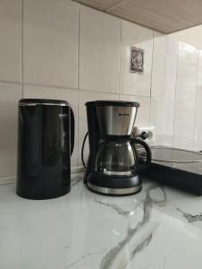 a coffee maker sitting on a counter in a kitchen at Salma Capsule Hostel in Bishkek