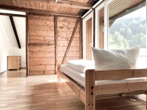 a bedroom with a bed and a large window at *Schwarzwald-Apartment 2° * in Elzach