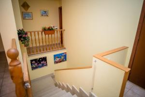 a hallway with a staircase with pictures on the wall at B&B Demarete sullo Ionio in Arenella