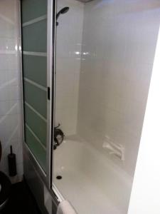 a bathroom with a bath tub with a shower stall at Seronera Wildlife Lodge in Serengeti National Park