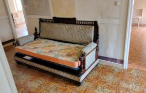 a small bed in a room with at ATTICO SULLA BOUGANVILLE (Albergo diffuso) in Corinaldo