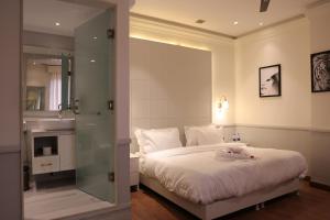 een slaapkamer met een bed en een glazen douche bij Hotel ND Manor in Dehradun