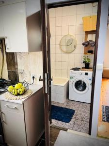 a kitchen with a sink and a washing machine at Nowomiejska Blisko Centrum in Suwałki