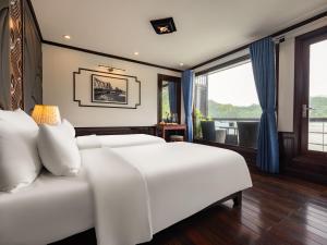 1 dormitorio con 2 camas blancas y ventana en Rosa Cruise, en Ha Long