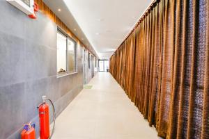 a hallway with curtains and a fire extinguisher at FabHotel Magnus in Surat