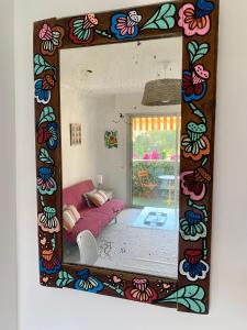 a mirror reflecting a bedroom with a bed in a room at Chez virginie : Appartement lumineux au calme. in Fréjus