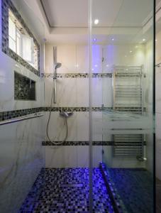 a shower with a glass door in a bathroom at Lume Athens in Athens