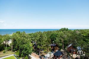 an aerial view of a house with the ocean in the background at Apartament Premium Sea-Pinea Apartments Pobierowo in Pobierowo