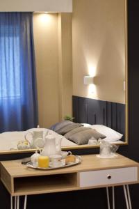 A bed or beds in a room at Minoa Athens Hotel
