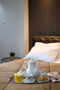 A bed or beds in a room at Minoa Athens Hotel