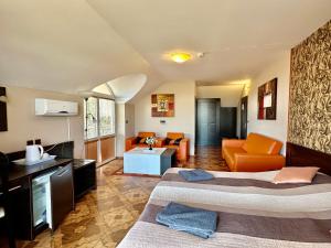 a hotel room with two beds and a living room at Mery Ján in Podhájska