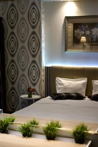 A bed or beds in a room at Minoa Athens Hotel