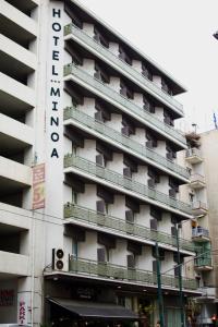 アテネにあるミノア アテネ ホテルのホテルの看板が横に建つ建物