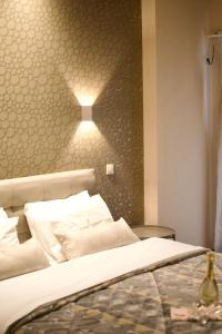A bed or beds in a room at Minoa Athens Hotel