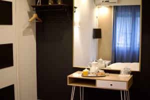 A bed or beds in a room at Minoa Athens Hotel