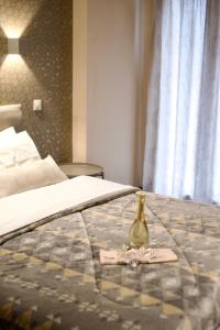 A bed or beds in a room at Minoa Athens Hotel