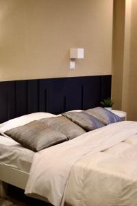 A bed or beds in a room at Minoa Athens Hotel