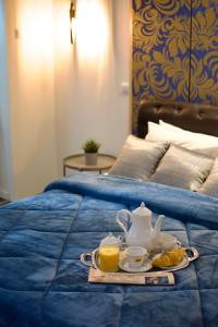A bed or beds in a room at Minoa Athens Hotel