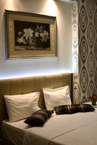 A bed or beds in a room at Minoa Athens Hotel