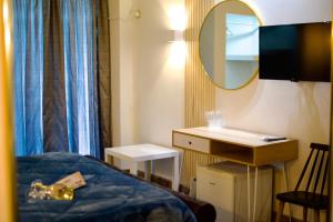 A bed or beds in a room at Minoa Athens Hotel