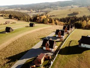 an aerial view of a row of houses in a field at Osada Dursztyn- Przystanek Podhale in Białka Tatrzanska