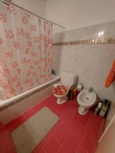 a bathroom with a toilet and a shower curtain at zacharenia's home in Mirodháton