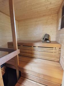 a sauna with a wooden bench and a speaker at Aava Sky Village Aurinkomaja in Aavasaksa