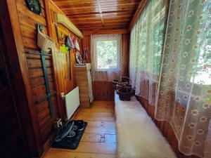 a hallway of a cabin with a wooden floor at Hunting lodge under the rock and the river Kretinka in Bystré