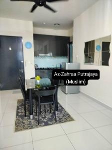 a dining room with a black table and chairs at Az-Zahraa Putrajaya - Residences Presint 8 in Putrajaya