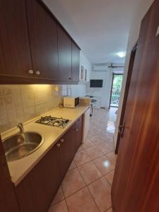 a kitchen with a sink and a stove at Old town - Studio1 in Tribunj