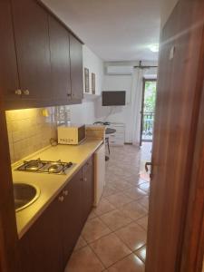 a kitchen with a sink and a stove top oven at Old town - Studio1 in Tribunj
