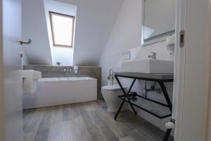 a bathroom with a sink and a tub and a toilet at Palatul Lugoj in Lugoj +51 photos