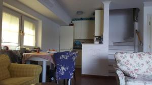 een keuken met een bank en een tafel in een kamer bij Kołatek Mazury Apartament z widokiem in Olsztynek