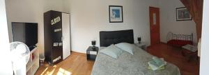 a bedroom with a bed with a black headboard at La haye Georget in Feneu