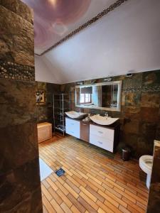 a bathroom with two sinks and a toilet in it at Apartments & wellness Kal Koritnica in Bovec