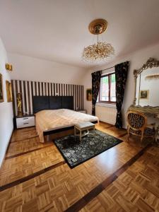 1 dormitorio con cama y lámpara de araña en Apartments & wellness Kal Koritnica, en Bovec
