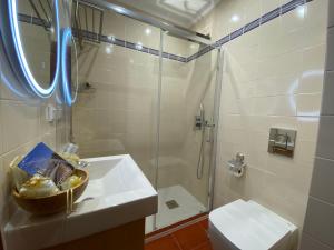 a bathroom with a shower and a sink and a toilet at Alvor Seven 10 in Alvor