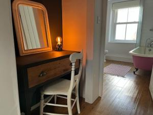 a bathroom with a dresser with a mirror and a sink at Dene Cottage in Stanton in Peak +35 photos